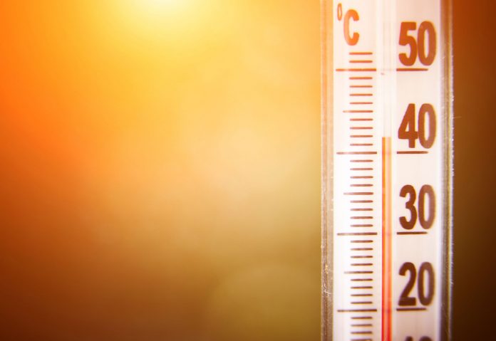 Close-up of a thermometer scale with bold numbers (30–60) on the right and an orange gradient background.